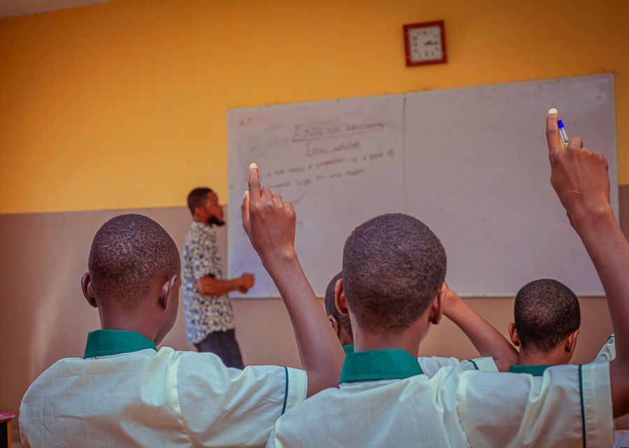 Pupils raising hands in class