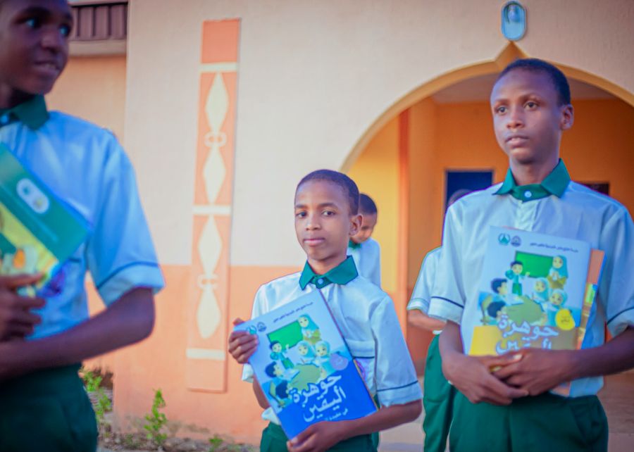 Pupil holding his Islamic studies book